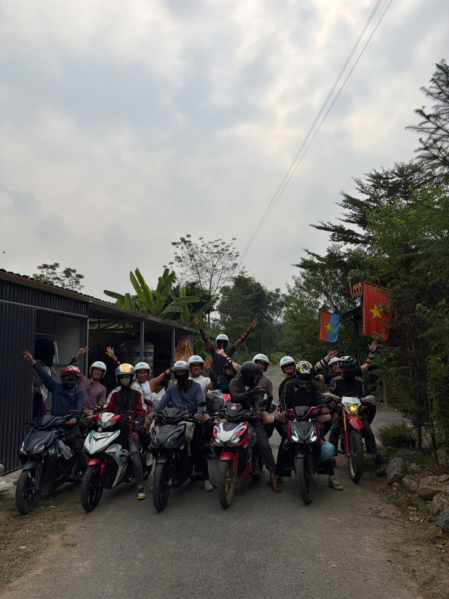 Loop Tours guests on motorbikes ready to set off on a village road